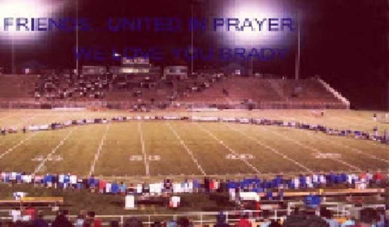 Fans gathered on the field: Friends united in prayer — we love you Brady